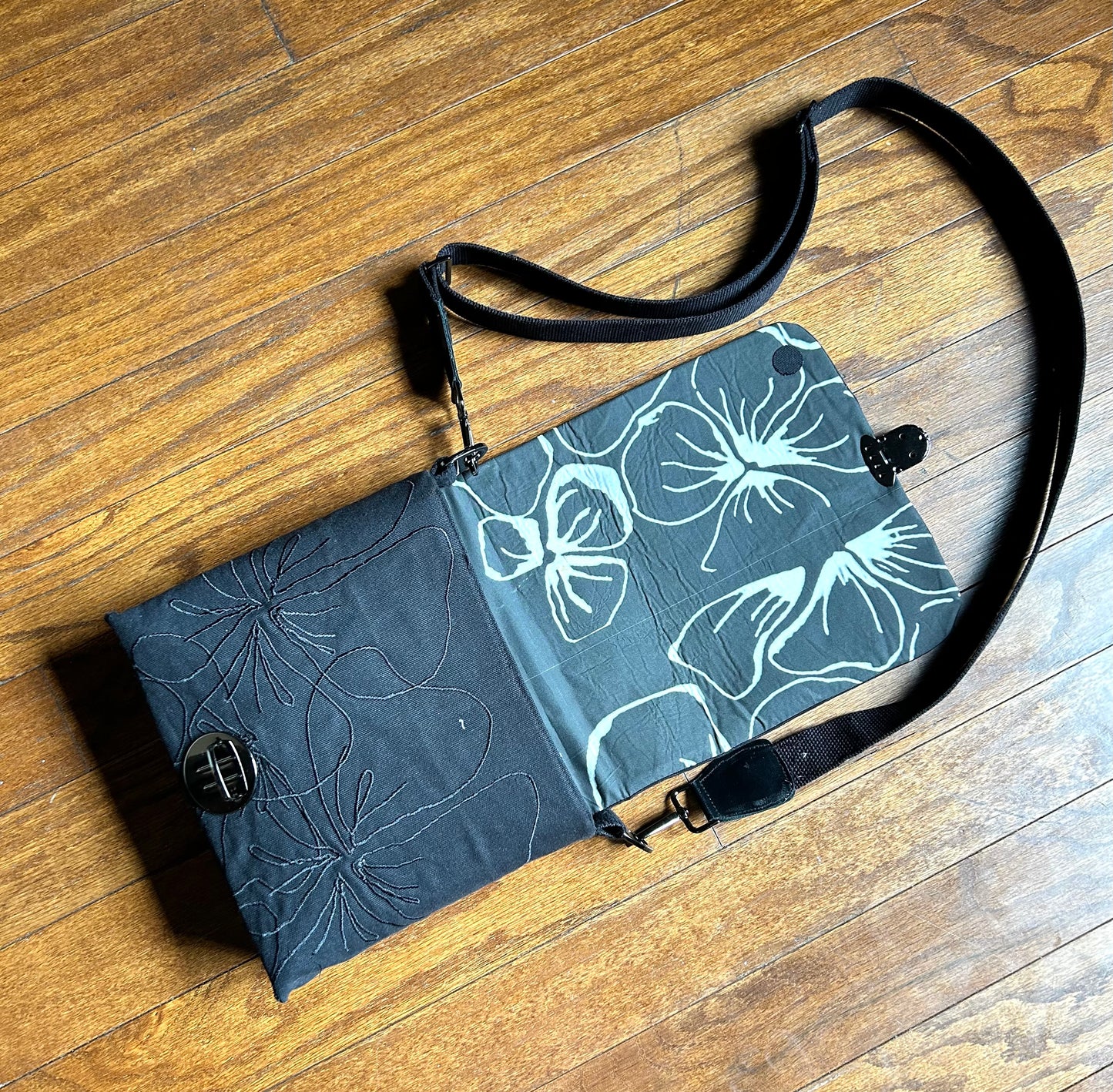 Mini embroidered canvas crossbody tote bag.